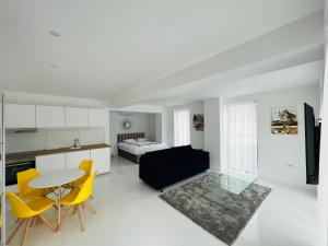 a living room with a table and chairs and a bed at Oxygen Residence D3 in Neptun