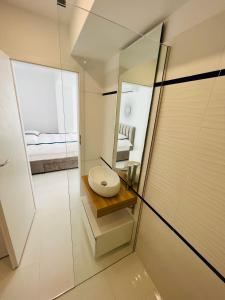 a bathroom with a toilet and a mirror at Oxygen Residence in Neptun