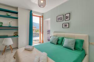 a bedroom with a blue bed and a window at La Casa del Pescatore in Cernobbio
