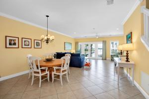 a dining room and living room with a table and chairs at Waterfront luxury Villa 30 with sunset views and boat slip townhouse in Marathon