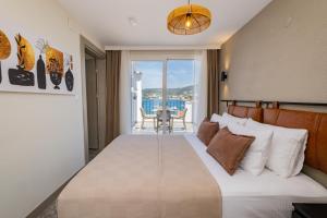 a bedroom with a bed with a view of the ocean at BD SUITES in Foça