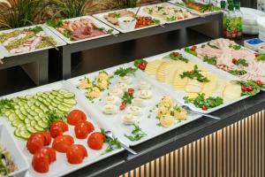 a buffet line with many different types of food at Stawa Apart Hostel in Świnoujście