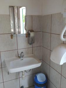a bathroom with a white sink and a mirror at KEMPIN - KANTIN egyéb szálláshely in Bázakerettye