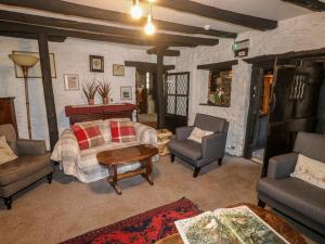 a bedroom with a bed and a couch and chairs at The Old Church House in Newton Abbot