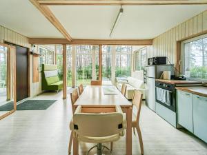 a kitchen and dining room with a table and chairs at River bank vacation home in Jūrmala