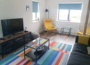 a living room with a couch and a tv at Bell View Holiday Home Sheeps Head in Bantry