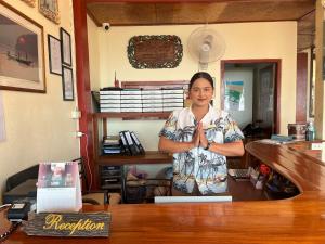 a woman standing in a room with her hands clasped at The Waterfront Hotel at Fishermans Village in Bophut  +32 photos