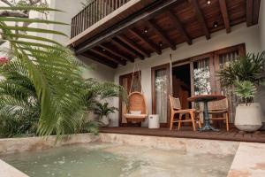 a house with a swimming pool and a table and chairs at Makani Luxury Cartagena in Tierra Bomba