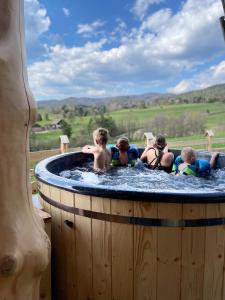 a group of children playing in a hot tub at Góralskie Domki na Podhalu - z jacuzzi, za dopłatą in Maniowy