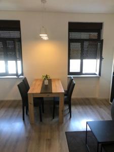 a dining room with a wooden table and chairs at Apartment Centro 2 in Kastav