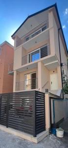 a large house with a gate in front of it at Gargovic Apartments in Budva