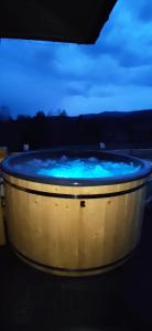 eine große Badewanne mit blauem Wasser in der Unterkunft Góralskie Domki na Podhalu - z jacuzzi in Maniowy
