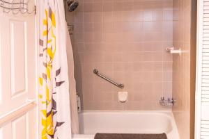 a bathroom with a bath tub with a shower curtain at Luxurious condo (1100 sq2) /private elevator! in Quebec City +12 photos
