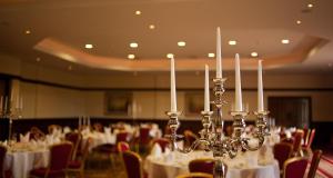 a room full of tables and chairs with white table cloth at Corr's Corner Hotel in Newtownabbey