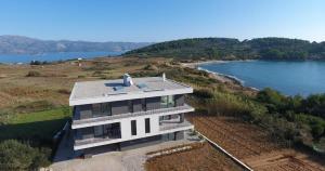 an aerial view of a house next to a lake at Luxury Hidden Oasis - Greca in Lumbarda