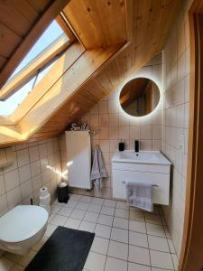 a bathroom with a toilet and a sink at Zentrale Wohnung in Crailsheim in Crailsheim