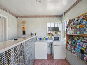 a kitchen with a counter and a sink and a microwave at Discovery Inn Monterey Bay in Seaside