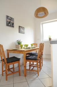 a dining room with a wooden table and chairs at Apartment Schmidt in Berlin