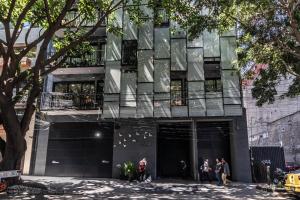 a building with people standing outside of it at Private Balcony Infinity Pool & Rooftop in La Roma - Queretaro in Mexico City