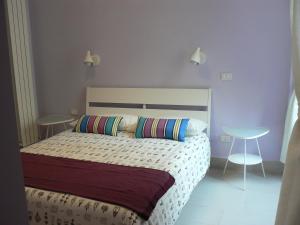 a bedroom with a bed with two tables and two chairs at Cerasella B&B in Naples