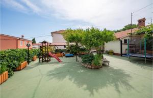 a backyard with a playground with a slide at Apartment Peruski Vi in Peruški +18 photos