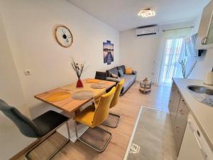 a kitchen and living room with a table and a couch at Julia in Biograd na Moru