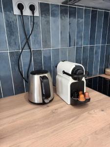 a kitchen counter with a coffee maker and a toaster at Très Parisien et ensoleillé in Paris