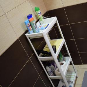 a shelf in the corner of a bathroom with toiletries at Vikendica Farah 