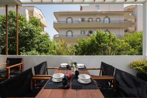 a table on a balcony with a building in the background at Icos City 2 in Hersonissos