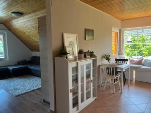 a living room with a table and a dining room at Katica Ház in Zánka