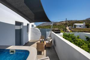 a view from the balcony of a villa with a swimming pool at Potamida Suites in Vóthon