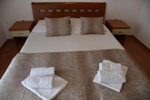 a bedroom with a bed with two towels on it at Guest House Zec in Budva +37 photos