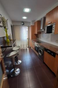 a kitchen with a counter and chairs in it at Mitxelena in Zarautz