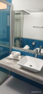 a bathroom with a sink and a mirror at Hotel Sevilla Perote in Perote