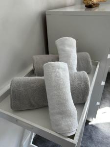 four towels on a shelf in a room at Entire Modern Apartment in Oban with Balcony in Oban