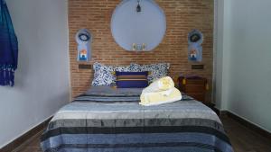 a bedroom with a bed with two towels on it at Blue House Town in Chefchaouene