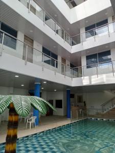 an empty pool in a building with a large swimming pool at HOTEL GLASS LAS VEGAS in La Vega