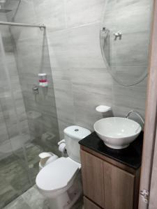 a bathroom with a toilet and a sink and a shower at HOTEL GLASS LAS VEGAS in La Vega