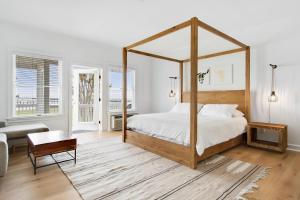 a bedroom with a canopy bed and a living room at 25 Bedrooms - Retreat Center Waterfront Renovated 