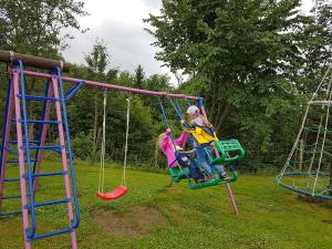 a person riding on a swing in a playground at Beaver Creek Ranch in Rothenthurm