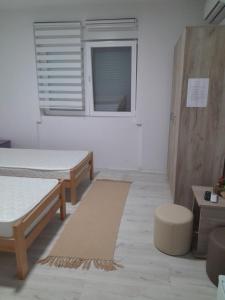 a room with two beds and a window at Lipov lad in Bela Crkva