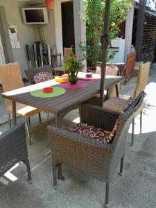 an outdoor table with chairs and a table with a centerpiece at Lipov lad in Bela Crkva