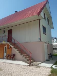 a building with a staircase on the side of it at Apartments Nemanja in Žabljak