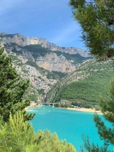 a view of a blue lake with a mountain at Studiowillangel in Régusse