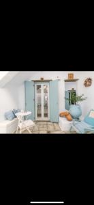 a room with two chairs and a table and a door at Studios Eleni II in Tinos