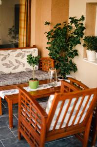 a living room with a couch and a table and chairs at Apartman Mina 1 in Vrdnik