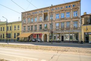 an empty street in front of a large building at Teatrum in Liepāja