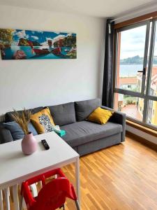 a living room with a couch and a table at Playa Miño in Miño
