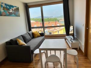 a living room with a couch and a table at Playa Miño in Miño