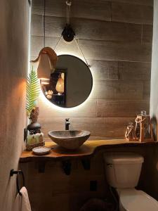 a bathroom with a sink and a toilet and a mirror at Lux Ph & Rooftop Terrace to Relax in Santiago de los Caballeros